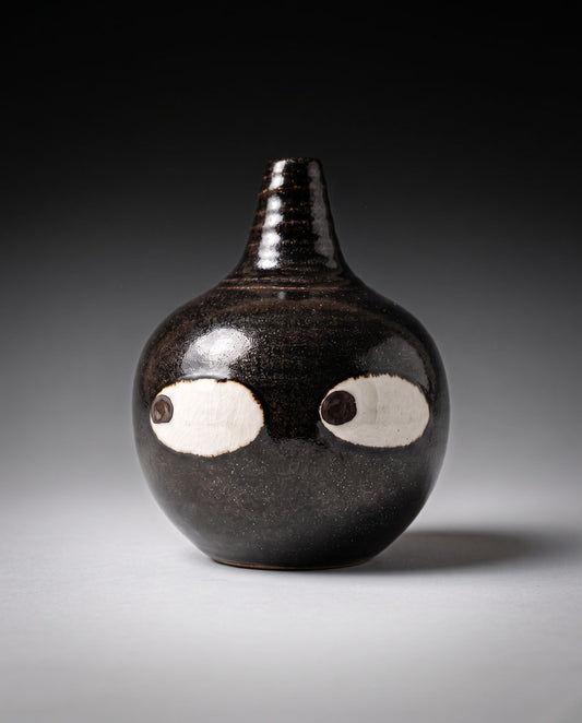 Black ceramic bud vase with two large white eyes, handmade in Korea, detail 2
