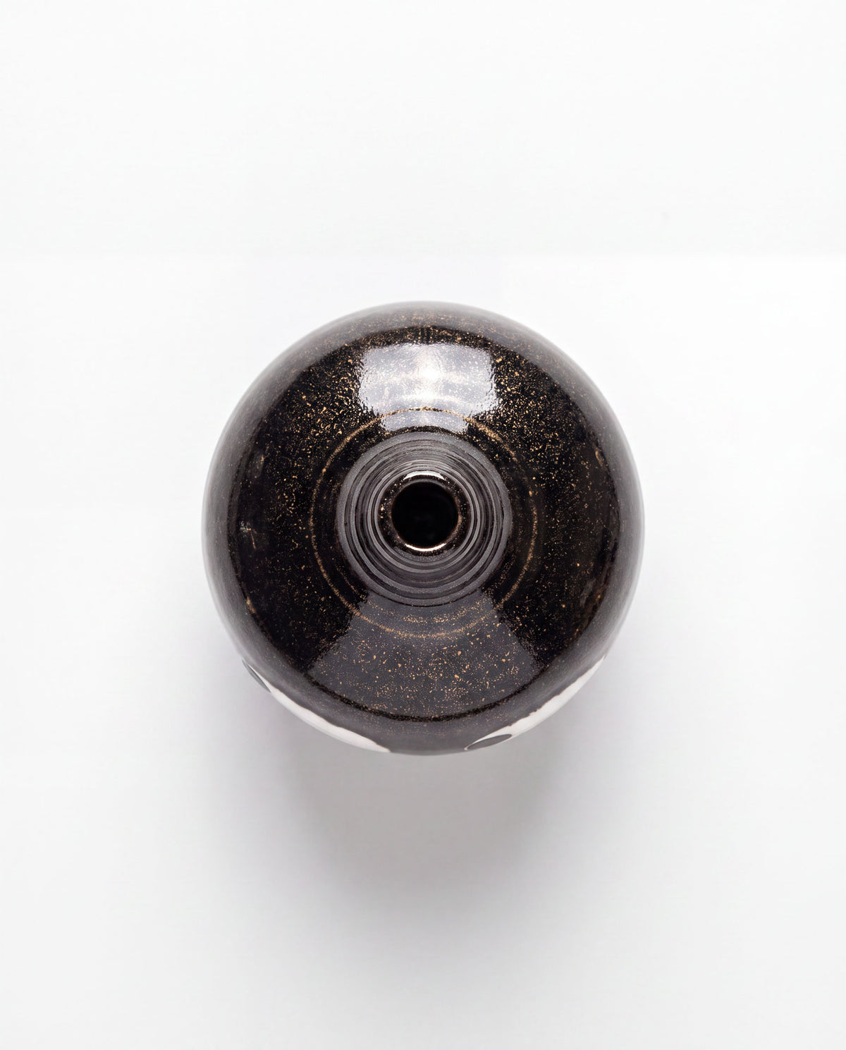 Black ceramic bud vase with two large white eyes, handmade in Korea, detail 3