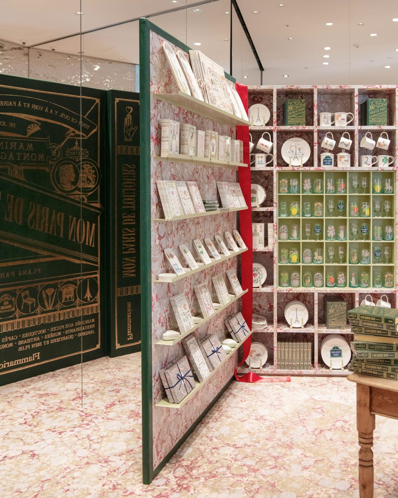 Marin Montagut pop-up in Seoul: giant green book, marbled-paper shelves of mugs, plates and glasses
