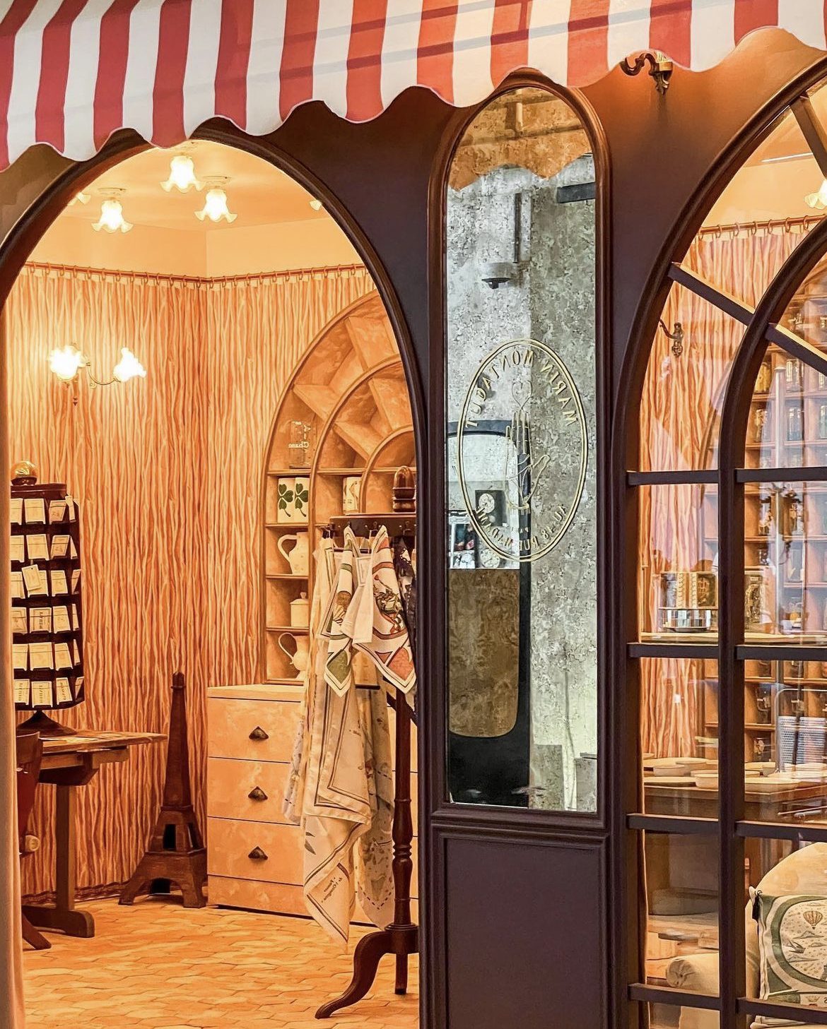 Inside the Marin Montagut pop-up: arched shelves, warm lights and tea towels